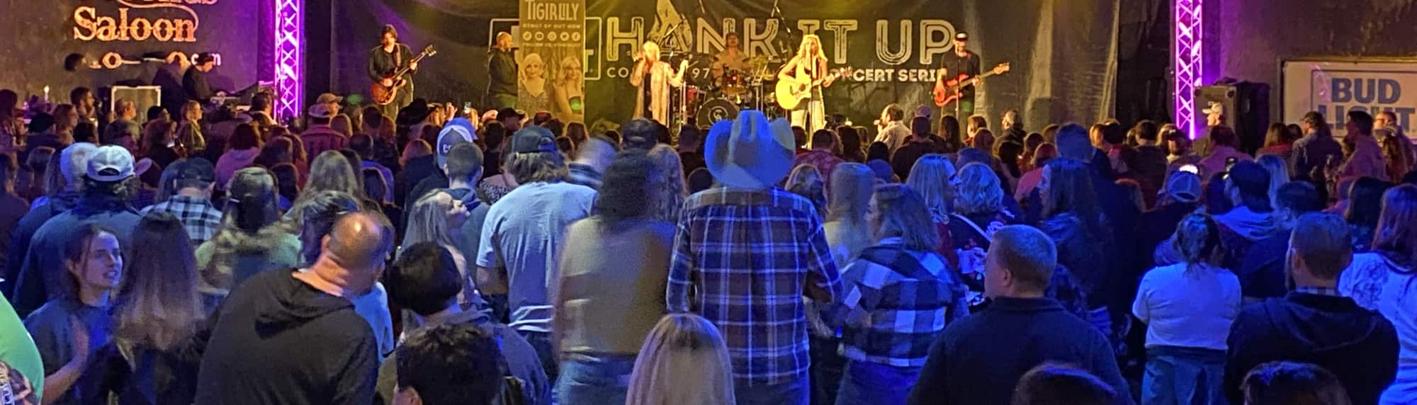 country concert with fans wearing cowboy hats Hartford