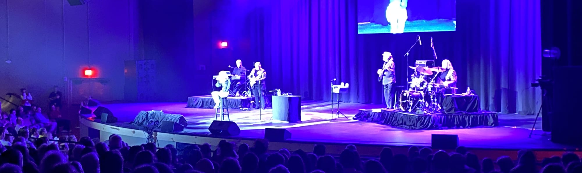 signer on stage in chair washed out by the lights Hartford